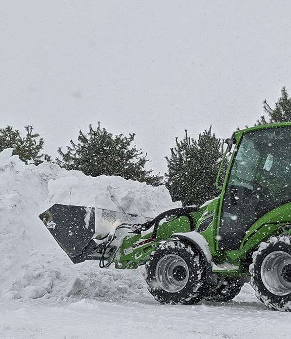 MintClean equipment clearing a large snow pile