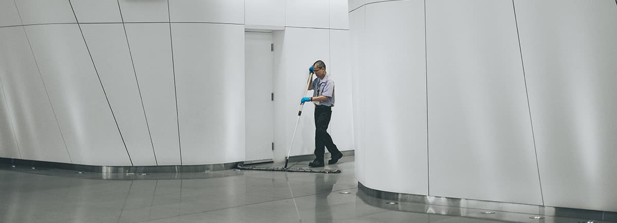 Janitor cleaning a modern commercial facility